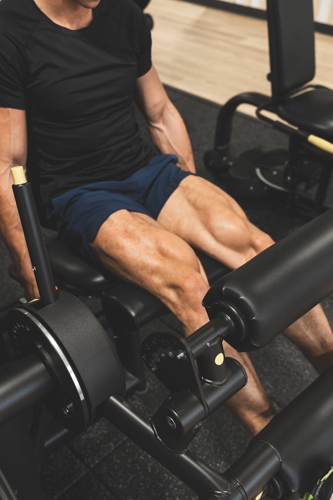 Muscular man working out on a leg press machine indoors, focusing on leg strength.