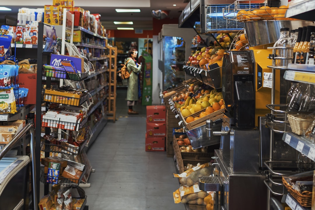 person choosing fresh vegetables over packaged snacks in grocery store aisle